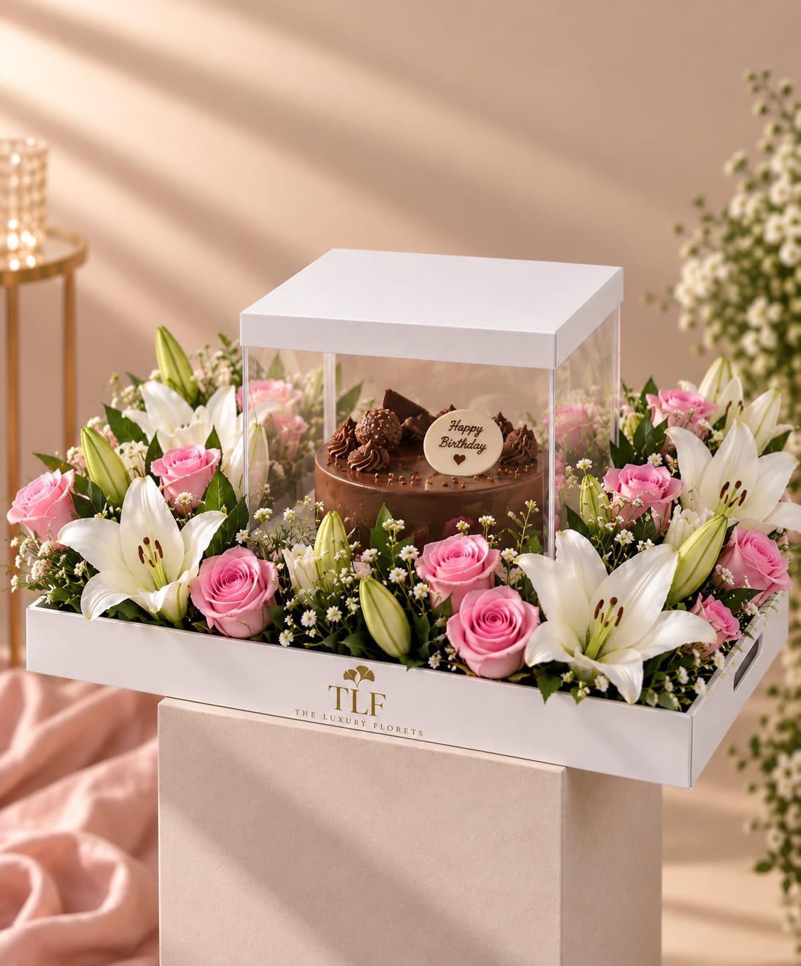 Glass-top luxury gift box with fragrant lilies, 30 fresh roses and a 500g celebration cake by The Luxury Florets, Delhi NCR